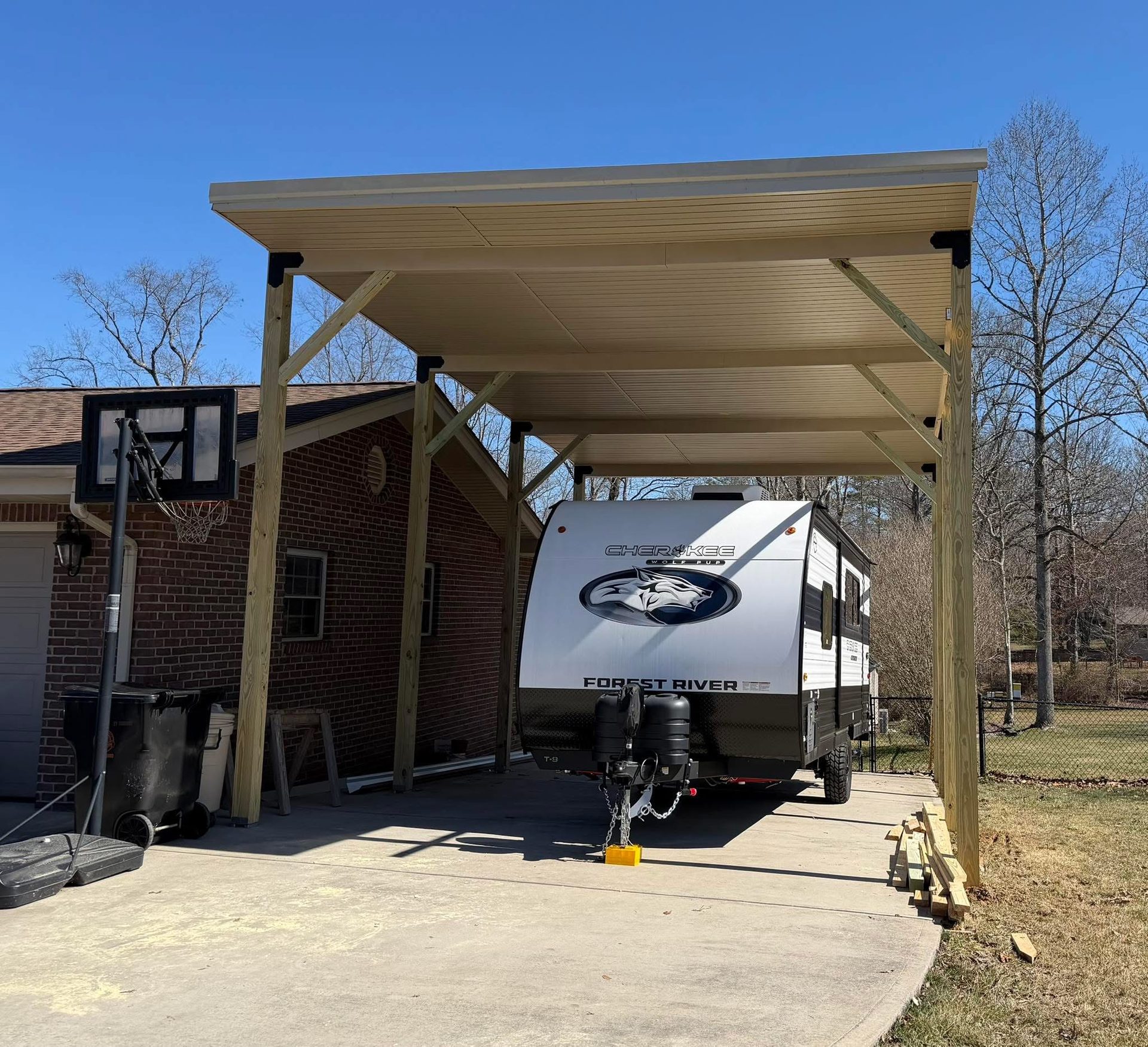 Completed attached carport with metal roof built by Adams Construction LLC